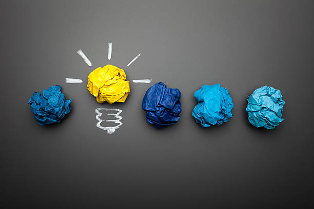Light bulb crumpled paper on a blackboard